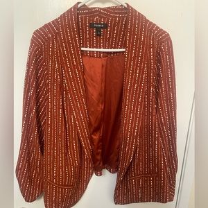 Rusty orange blazer with cream detailed design.